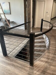 Custom arched black steel cable railing in Lake Norman home