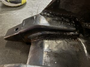 Custom welding detail of bucket tooth rebuild, deep weld build-up