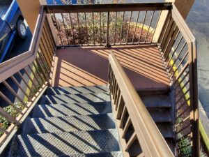 Custom outdoor deck with metal picket railing and stairs