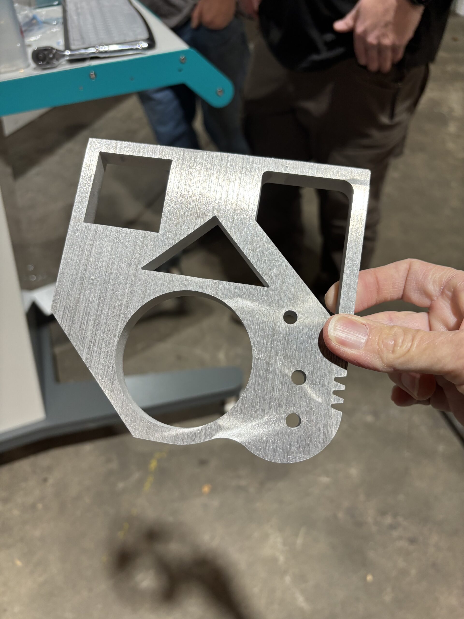 Precision waterjet-cut steel bracket showing complex geometry and clean edges