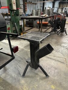 Custom rocket stove design detail with chimney and cook surface